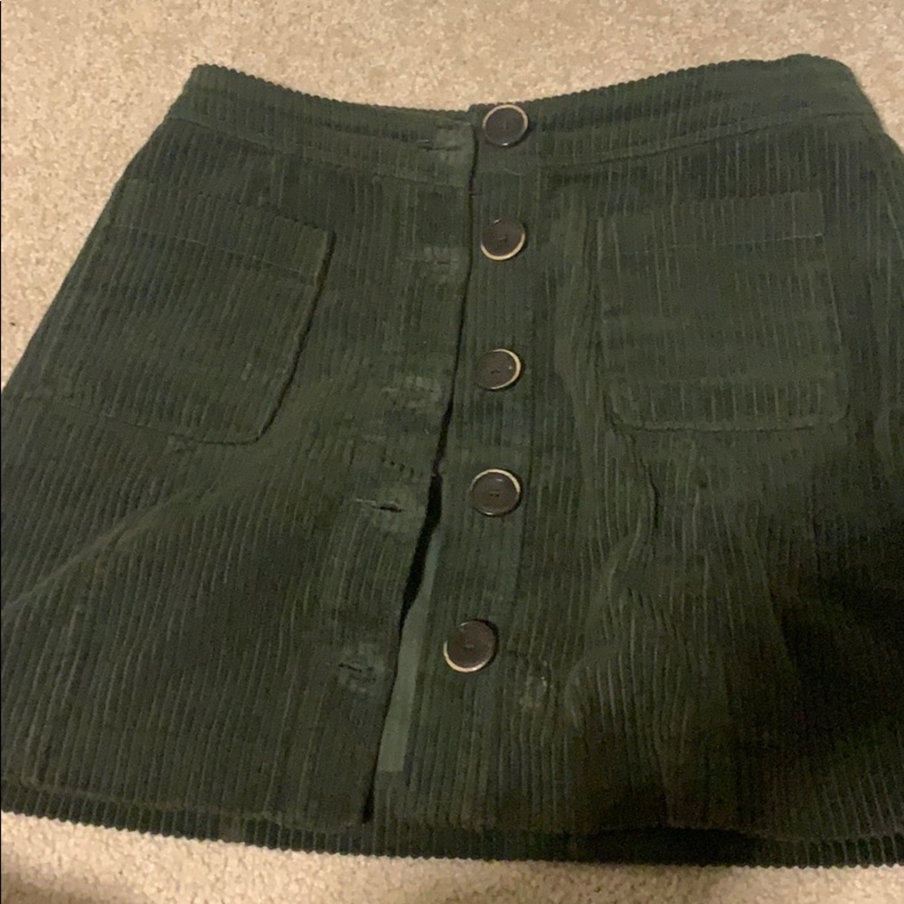 A Green button down skirt
